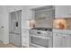 Stainless steel appliances and designer backsplash highlight this kitchen at 332 Sugarview Rd # 16, Sugar Hill, GA 30518