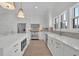 Open concept kitchen with white cabinets and a large island at 332 Sugarview Rd # 16, Sugar Hill, GA 30518