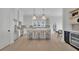 Open concept kitchen features an island, wine fridge, and breakfast bar at 332 Sugarview Rd # 16, Sugar Hill, GA 30518