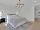 Spacious main bedroom with a large bed, light walls, and a chandelier at 332 Sugarview Rd # 16, Sugar Hill, GA 30518