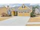 Eye-catching yellow house with stone accents and a two-car garage at 511 Millside Trl, Canton, GA 30114