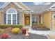 Inviting front porch with stone details and a bright yellow door at 511 Millside Trl, Canton, GA 30114