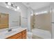 Bathroom with tub shower combo and wood vanity at 2105 Rock Ct, Loganville, GA 30052