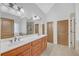 Double vanity bathroom with a large mirror and tile floors at 2105 Rock Ct, Loganville, GA 30052
