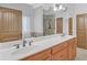 Double vanity bathroom with a large mirror and tile floors at 2105 Rock Ct, Loganville, GA 30052