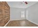 Bedroom with wood-look accent wall and ceiling fan at 2105 Rock Ct, Loganville, GA 30052
