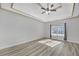 Primary bedroom with hardwood floors and tray ceiling at 2105 Rock Ct, Loganville, GA 30052