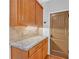 Kitchen features granite countertop and oak cabinets at 2105 Rock Ct, Loganville, GA 30052