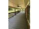 Covered back porch with wooden flooring and a wooded backyard at 6494 Pleasant Dr, Winston, GA 30187