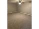 Finished basement with neutral carpet and ceiling fan at 6494 Pleasant Dr, Winston, GA 30187