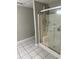 Modern shower with gray walls and square tile flooring in updated bathroom at 6494 Pleasant Dr, Winston, GA 30187