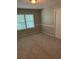 Carpeted bedroom featuring natural lighting, a ceiling light, and a door at 6494 Pleasant Dr, Winston, GA 30187