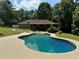 Backyard features a private pool surrounded by lush greenery creating a serene outdoor oasis at 6494 Pleasant Dr, Winston, GA 30187