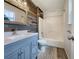 Updated bathroom with gray vinyl flooring and a rustic accent wall at 108 Ridgefield Dr, Douglasville, GA 30134