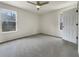 Well-lit bedroom with gray carpeting and ceiling fan at 108 Ridgefield Dr, Douglasville, GA 30134