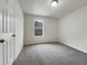 Simple bedroom with gray carpeting and neutral walls at 108 Ridgefield Dr, Douglasville, GA 30134