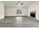 Spacious living room with gray vinyl flooring and a stone fireplace at 108 Ridgefield Dr, Douglasville, GA 30134