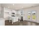 Modern kitchen with white cabinets, island, and stainless steel appliances at 3238 Champions Way, Loganville, GA 30052