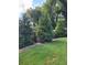 Landscaped backyard with lush greenery and tall trees at 151 Roy St # A & B, Canton, GA 30114