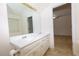 Bathroom with double vanity and a view into the bedroom at 190 Wynfield Dr, Covington, GA 30016