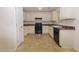 Open kitchen layout with white cabinets and black appliances at 190 Wynfield Dr, Covington, GA 30016