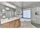 Elegant bathroom with a soaking tub, walk-in shower, and modern vanity at 3350 Vista Creek Dr, Dacula, GA 30019