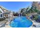 Large, freeform pool with stone coping and waterfall feature at 3350 Vista Creek Dr, Dacula, GA 30019