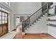 Grand staircase with dark wood railing and hardwood floors at 3350 Vista Creek Dr, Dacula, GA 30019