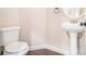 Small bathroom with pedestal sink and toilet at 960 N Grand Nw Ave, Atlanta, GA 30318