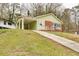 Light green house with a long driveway and covered porch at 2600 Nw Baker Rd, Atlanta, GA 30318