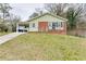 Charming ranch home with brick and siding exterior, a carport and a landscaped lawn at 2600 Nw Baker Rd, Atlanta, GA 30318