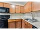 Modern kitchen with stainless steel appliances and wood cabinets at 2600 Nw Baker Rd, Atlanta, GA 30318