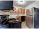 Modern kitchen with stainless steel appliances and wood cabinets at 2600 Nw Baker Rd, Atlanta, GA 30318