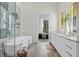 Modern bathroom with soaking tub, double vanity, and large mirror at 40 12Th Ne St # 1004, Atlanta, GA 30309