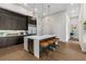 Open kitchen with island seating, wine cooler, and modern finishes at 40 12Th Ne St # 1004, Atlanta, GA 30309