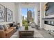 Spacious living room with city views and a cozy fireplace at 40 12Th Ne St # 1004, Atlanta, GA 30309