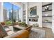 Modern living room with a fireplace and built in shelving, offering city views at 40 12Th Ne St # 1004, Atlanta, GA 30309