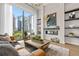 Living room with floor to ceiling windows, fireplace and city views at 40 12Th Ne St # 1004, Atlanta, GA 30309