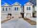 Two-story townhome with neutral siding and attached garage at 6166 Ripple Way # 79, South Fulton, GA 30349