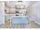 Modern kitchen with gray cabinets, granite island and lighting fixture at 6166 Ripple Way # 79, South Fulton, GA 30349