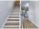 Modern staircase with light wood treads and white risers, leading to the upper level at 6166 Ripple Way # 79, South Fulton, GA 30349