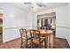 Dining room with hardwood floors, wooden table and view into the living room at 1980 Campfire Dr, Riverdale, GA 30296