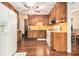 Kitchen with wood cabinets, white appliances, and hardwood floors at 1980 Campfire Dr, Riverdale, GA 30296