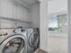 Laundry room with washer, dryer, and shelving at 3338 Peachtree Ne Rd # 1104, Atlanta, GA 30326