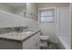 Bathroom featuring tiled walls, granite countertop vanity, and a window bringing in natural light at 3482 Scenic Dr, Atlanta, GA 30344