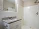 Bathroom featuring tiled walls, a granite countertop vanity, and a shower, creating a clean functional space at 3482 Scenic Dr, Atlanta, GA 30344