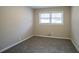 Cozy bedroom with neutral walls, soft carpet, a window, and crisp white trim creating a peaceful retreat at 3482 Scenic Dr, Atlanta, GA 30344