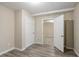 Bright bedroom featuring wood-look floors, neutral walls, and white trim, with a view into another room at 3482 Scenic Dr, Atlanta, GA 30344