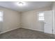 Sunlit bedroom showcasing neutral walls, soft carpet, and a large window, creating a bright and inviting space at 3482 Scenic Dr, Atlanta, GA 30344