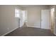 Bedroom with neutral walls, plush carpet, and doorways leading to an adjoining room and bathroom at 3482 Scenic Dr, Atlanta, GA 30344